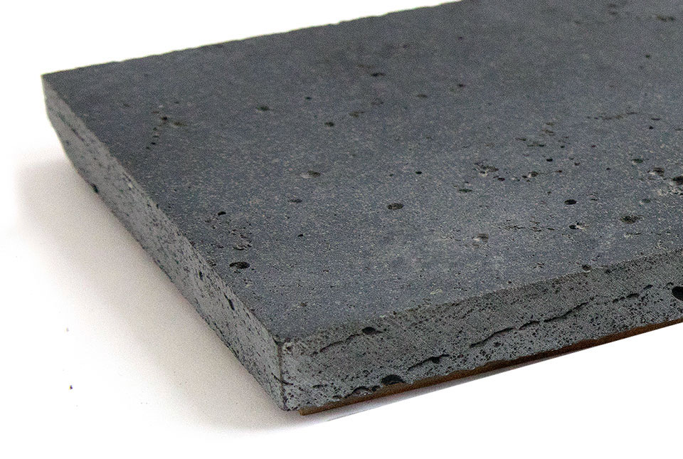 Norstone Lava Stone Planc with a honed finish in graphite color shown from a side view